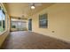 Relaxing covered patio features tile floor, screened enclosure, and ceiling fans at 1457 Teal Dr, Kissimmee, FL 34759