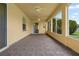 Enclosed patio features tile flooring, ceiling fans, and a serene backyard view at 1457 Teal Dr, Kissimmee, FL 34759
