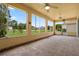Enclosed patio featuring tile floors, ceiling fans, and backyard views at 1457 Teal Dr, Kissimmee, FL 34759