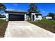 Charming single Gathering home with a driveway, a two-car garage, and manicured landscaping at 15062 Sw 43Rd Avenue Rd, Ocala, FL 34473