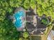 Aerial view of a community pool surrounded by mature trees and a well-maintained building at 1547 Farrindon Cir # 1547, Lake Mary, FL 32746