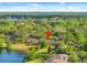 Scenic aerial view of homes by a lake, surrounded by verdant trees and community amenities at 1547 Farrindon Cir # 1547, Lake Mary, FL 32746