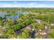 Wonderful aerial view of this home community featuring lush trees, a pond, and resort-style amenities at 1547 Farrindon Cir # 1547, Lake Mary, FL 32746