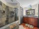Elegant bathroom featuring a tile shower, sleek vanity with granite countertops, and a decorative window at 1547 Farrindon Cir # 1547, Lake Mary, FL 32746