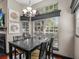 Bright dining space with modern chandelier and large windows showcasing the outdoor scenery at 1547 Farrindon Cir # 1547, Lake Mary, FL 32746