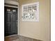 Inviting entryway with a decorative front door and window showcasing a home security system at 1547 Farrindon Cir # 1547, Lake Mary, FL 32746