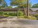 Exterior view of a well-maintained home with designated parking and mature trees overhead at 1547 Farrindon Cir # 1547, Lake Mary, FL 32746