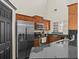 Well-equipped kitchen featuring stainless steel appliances, granite countertops, and wooden cabinets at 1547 Farrindon Cir # 1547, Lake Mary, FL 32746