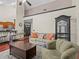 Open-concept living area with hardwood floors, a comfortable sofa, and ample natural light at 1547 Farrindon Cir # 1547, Lake Mary, FL 32746