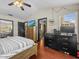 Bright main bedroom with a dresser, dark wood floors, a ceiling fan, and natural light at 1547 Farrindon Cir # 1547, Lake Mary, FL 32746