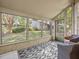 Relaxing screened porch with outdoor seating and views of the lush, green backyard at 1547 Farrindon Cir # 1547, Lake Mary, FL 32746
