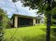 Backyard view featuring a screened porch and lush green lawn at 1573 Amber Leaf Cir, Ocoee, FL 34761