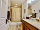 Charming bathroom featuring a vanity, toilet, shower with curtain, and lovely decorative touches at 1573 Amber Leaf Cir, Ocoee, FL 34761