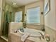 Luxurious bathroom with soaking tub, tiled surround, and shower with glass door at 1573 Amber Leaf Cir, Ocoee, FL 34761
