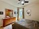 Well-lit bedroom showing a wooden dresser, mirror, and comfortable bed with light coming through the window at 1573 Amber Leaf Cir, Ocoee, FL 34761
