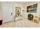 Inviting foyer featuring light wood-look floors, decorative mirror and console table, with an art piece at 1573 Amber Leaf Cir, Ocoee, FL 34761