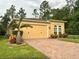 Lovely home with a two-car garage, brick-paved driveway, and beautiful landscaping at 1573 Amber Leaf Cir, Ocoee, FL 34761