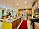Bright, open kitchen with stainless steel appliances and a breakfast bar overlooking the dining area at 1573 Amber Leaf Cir, Ocoee, FL 34761