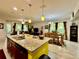 Open-concept kitchen with island and view into the living and dining areas at 1573 Amber Leaf Cir, Ocoee, FL 34761