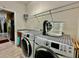 Well-equipped laundry room with modern washer and dryer, granite countertop, sink, and overhead shelving at 1573 Amber Leaf Cir, Ocoee, FL 34761