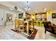 Open living space showing the kitchen with bar seating, dining area, and living room at 1573 Amber Leaf Cir, Ocoee, FL 34761