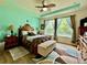 The main bedroom features a decorative ceiling fan, two side tables, and large windows at 1573 Amber Leaf Cir, Ocoee, FL 34761