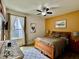 Comfortable bedroom featuring a ceiling fan, natural light, and stylish décor elements at 1573 Amber Leaf Cir, Ocoee, FL 34761