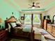 The main bedroom has bright walls, decorative ceiling fan, bench seat, and large dresser at 1573 Amber Leaf Cir, Ocoee, FL 34761