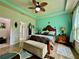 Comfortable main bedroom with a decorative ceiling fan, tiled floor, and ample natural light at 1573 Amber Leaf Cir, Ocoee, FL 34761