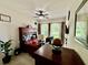 Functional home office with built-in desk, natural light, and ceiling fan at 1573 Amber Leaf Cir, Ocoee, FL 34761