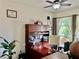 Bright office with wood desk and cabinets, ceiling fan, and large window at 1573 Amber Leaf Cir, Ocoee, FL 34761
