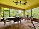 Large screened porch boasts brick pavers, ceiling fans, comfortable seating and a tranquil backyard view at 1573 Amber Leaf Cir, Ocoee, FL 34761