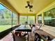 Beautiful screened-in porch with brick flooring, ceiling fans, and views of the private backyard at 1573 Amber Leaf Cir, Ocoee, FL 34761