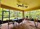 Spacious screened porch features brick pavers, ceiling fans, and comfortable seating areas at 1573 Amber Leaf Cir, Ocoee, FL 34761