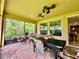Inviting screened porch with brick flooring, ceiling fans, and views of the lush backyard at 1573 Amber Leaf Cir, Ocoee, FL 34761