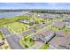 Aerial view of a residential community featuring a pool, park, and beautiful lake at 19105 Planetree St, Orlando, FL 32827