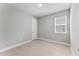 Neutral bedroom with light-colored floors, neutral walls, and a window at 19105 Planetree St, Orlando, FL 32827