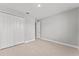 This bedroom features light wood look floors, a spacious closet, and light gray walls at 19105 Planetree St, Orlando, FL 32827