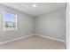 Bright bedroom featuring wood-look floors, neutral walls, and a window offering a scenic outdoor view at 19105 Planetree St, Orlando, FL 32827