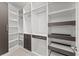 Spacious walk-in closet with custom shelving and drawer units for optimal organization at 19105 Planetree St, Orlando, FL 32827