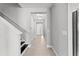 Hallway with tiled flooring and black staircase, bathed in natural light at 19105 Planetree St, Orlando, FL 32827
