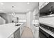 Contemporary kitchen with stainless steel appliances, white cabinets, and a large center island at 19105 Planetree St, Orlando, FL 32827