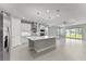 Open-concept kitchen with a large island, modern appliances, and sleek cabinetry at 19105 Planetree St, Orlando, FL 32827