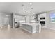 Bright, open kitchen featuring a large island, modern appliances, and ample cabinet space at 19105 Planetree St, Orlando, FL 32827