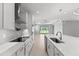 Modern kitchen features white cabinets, stainless steel appliances, and large countertops at 19105 Planetree St, Orlando, FL 32827