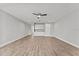 Spacious living room featuring light wood floors and a modern ceiling fan at 19105 Planetree St, Orlando, FL 32827