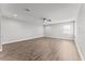 Large living room featuring a ceiling fan, and wood look floors at 19105 Planetree St, Orlando, FL 32827
