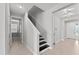 Entryway staircase with neutral wall color, tiled floor, and contemporary lighting at 19105 Planetree St, Orlando, FL 32827