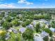 Scenic aerial view of a neighborhood showcasing lush greenery and a peaceful lake in the distance at 2009 E Grant St, Orlando, FL 32806