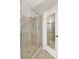 Tile shower with glass door features chrome hardware and tile flooring, showcased with an open doorway at 2009 E Grant St, Orlando, FL 32806